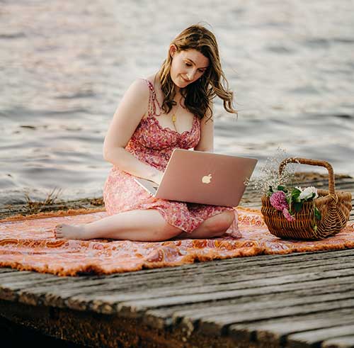 Emma with laptop by the water